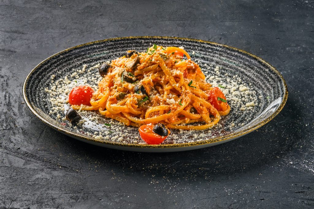 Pasta with tomato, parmesan cheece and olives